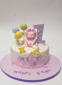 a birthday cake decorated with animals and letters