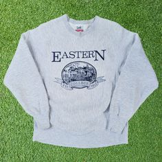 **Vintage Lee Tag Eastern College Sweatshirt** 👕 M-L Adult Size 🎨 Big Graphic 🧥 Crewneck Pullover  Description Step back in time with this vintage Lee Tag Eastern College sweatshirt. Featuring a striking big graphic, this cozy crewneck pullover is the perfect addition to your collection.  Features - 🎨 Big Graphic: Adds a touch of retro charm to your wardrobe. - 🧥 Crewneck Pullover: Offers comfort and style in one. - 👕 M-L Adult Size: Fits a range of body types for a relaxed feel.  Size Thi Vintage Long Sleeve T-shirt For College, Vintage Relaxed Fit Crew T-shirt, Vintage Crew Neck T-shirt Relaxed Fit, Vintage Sweater With Letter Print And Long Sleeves, Vintage Long Sleeve Sweater With Letter Print, Vintage Letter Print Sweater For Winter, Vintage Letter Print Winter Sweater, Vintage Crew Neck Relaxed Fit Top, Vintage Relaxed Fit Crew Top