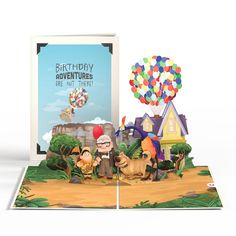 an open birthday card with balloons and animals