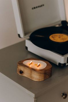 a record player with two candles in front of it