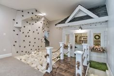 a house with fake rocks on the wall and stairs leading up to it's entrance