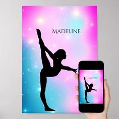 a person holding up a cell phone next to a book with a silhouette of a ballerina on it