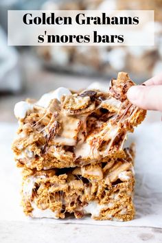 golden graham s'mores bars stacked on top of each other with the text overlay