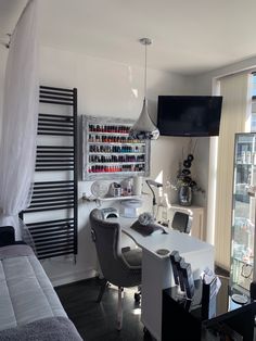 a room with a bed, desk and shelves on the wall next to a window