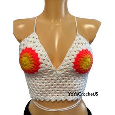 a crocheted halter top with flowers on the front and bottom is shown