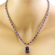 Stamped: 14KTotal Necklace Weight: 29.8 GramsNecklace Length: 18 InchesCenter Amethyst Weight: 15.00 Carat (20.10x15.10 Millimeters)Side Amethyst Weight: 26.00 Carat (6.00x4.00 Millimeters)Diamond Weight: 2.05 Carat (F-G Color, VS2-SI1 Clarity) Face Measures: 24.85x19.40 Millimeter SKU: [600601] Luxury Purple Diamond Necklace, Formal Purple Gemstone Necklace, Purple Diamond Necklace In Fine Jewelry Style, Purple Diamond Necklace Fine Jewelry, Fine Jewelry Purple Diamond Necklace, Formal Amethyst Necklace In Fine Jewelry Style, Formal Fine Jewelry Amethyst Necklaces, Formal Fine Jewelry Amethyst Necklace, Luxury Purple Necklace For Anniversary