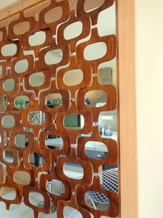 a room divider made out of wood and mirrors