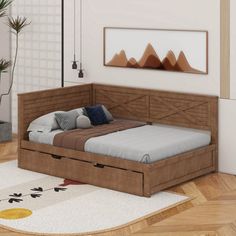 a bed sitting on top of a hard wood floor next to a plant in a room