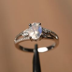 It is natural moonstone ring, the main stone is about 6mm*8mm, oval cut, The basic metal is sterling silver and plated with rhodium.To change the metal to a solid gold (white/rose) or platinum is also available, please ask for a quotation if you want.You can also go to my shop Home for more elegant rings: https://www.etsy.com/shop/godjewelry?ref=hdr_shop_menuMore alexandrite  rings:  https://www.etsy.com/shop/godjewelry?ref=seller-platform-mcnav&search_query=moonstoneCustomization is always Basic Silver Rings, Elegant Sterling Silver Moonstone Ring With Center Stone, Elegant Moonstone Ring With Center Stone In Sterling Silver, Elegant Moonstone Ring With Center Stone, Dainty Oval Moonstone Promise Ring, Silver Solitaire Moonstone Ring, Silver Solitaire Moonstone Ring, Fine Jewelry, Fine Jewelry Silver Solitaire Moonstone Ring, Oval Moonstone Fine Jewelry Ring