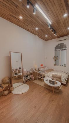 an empty room with wooden floors and white walls is pictured in this image, there are teddy bears on the floor