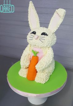 a cake made to look like a bunny holding a carrot