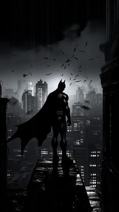 a batman standing on top of a building in the dark