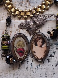 An assemblage of vintage components with a Victorian sensibility. The central pendant is a vintage brass French angel wing finding suspending a vintage Victorian style brass locket with a cameo of a Grecian goddess in profile. Inside I've mounted a replica of an antique angel painting and a sacred heart. Both are under clear resin in place of glass inserts. I've used Venetian style vintage lampwork beads, faceted French jet beads, two vintage intaglio pendants from West Germany, and two Victorian mother of pearl boot buttons. Vintage gold plated book chain finishing with rolo chain. Length can be adjusted. Unique Vintage Style Medallion Necklace, Unique Medallion Necklace From Vintage Collection, Antique Brass Locket Necklace With Charms, Antique Silver Vintage Locket Necklace, Antique Silver Vintage Locket Necklace With Charm, Bronze Medallion Necklace For Vintage Collection, Antique Gold Spiritual Necklace With Vintage Charm, Unique Antique Gold Medallion Necklace, Artistic Gold Jewelry With Vintage Charm