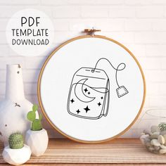 a cross stitch pattern with an image of a cat in a bag on the screen