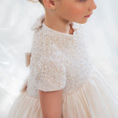 This elegant ivory dress is the perfect choice for your little one's special occasions. With delicate bead and pearl details and a princess-style cut, this Dubai-inspired dress will make your child feel like royalty. Ideal for weddings, birthdays, and first communions, it exudes elegance and grace. Don't miss out on the Dreamy Vow 2024 J053 dress for an unforgettable celebration. Cream Tulle First Communion Dress For Pageant, Cream Tulle First Communion Dress, Elegant Embellished Princess Dress For Wedding, White Princess Dress With Pearl Embroidery, Elegant Embellished Princess Wedding Dress, Elegant Princess Dress With Pearl Embroidery And Tulle, Cream Tulle Gown For Pageant, Elegant Tulle Princess Dress With Pearl Embroidery, Elegant Wedding Princess Dress With Pearl Embroidery