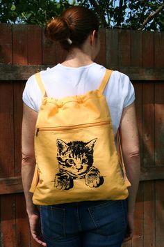 Cat Canvas Backpack A sweet, little, kitty cat backpack that you can take everywhere you go! Awww... Your kitty has been printed on a khaki, 100% cotton, canvas backpack using non-toxic, water based ink. It measures 14 ½ inches wide by 17 ½ inches tall, with cotton webbing, non-adjustable, straps. There is one large main compartment and a front zippered pocket. A great bag for carrying school books or anything you need for a day at the beach. Just the right size for your laptop too! Available in Canvas Laptop Bag, Kitty Backpack, Baby Girl Clothes Winter, Adventure Backpack, Cat Backpack, Eco Friendly Bags, Shoe Bags, Backpack Brands, School Books