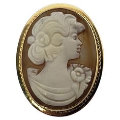 Vintage 18 Karat Yellow Gold Cameo Brooch/Pendant- This elegant cameo features a lovely lady in profile framed in beautifully detailed 18K yellow gold. Can be worn as a brooch or a pendant. Size: 23 mm x 18 mm Weight: 1.7 dwt. / 2.7 gr. Stamped: 750 95 NV Very good condition, professionally polished. Will come packaged in a gift box or pouch (when possible) and will be shipped U.S. Priority Mail Insured. DV092622/17KCS Classic Cameo Brooches For Wedding, Luxury Yellow Gold Cameo Brooch, Elegant Formal Brooch With Intaglio Detail, Elegant Cameo Brooch For Formal Wear, Elegant Intaglio Brooch For Formal Occasions, Elegant Formal Cameo Brooch, Classic Gold Brooch With Intaglio Detail, Classic Gold Intaglio Brooch, Classic Gold Intaglio Brooches