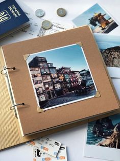 an open book with pictures on it sitting next to some coins and other things that are laying around