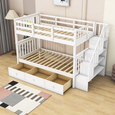 a white bunk bed sitting on top of a wooden floor