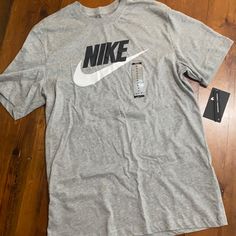 Grey Nike Logo Tshirt Nike Cotton T-shirt In Athletic Heather, Nike Cotton Crew Neck T-shirt, Nike Graphic Print T-shirt In Athletic Heather, Athletic Heather T-shirt With Logo Crew Neck, Athletic Heather Crew Neck T-shirt With Logo, Grey Logo Print Crew Neck T-shirt, Casual Nike Crew Neck T-shirt, Casual Athletic Heather T-shirt With Letter Print, Nike Gray Graphic Print Top