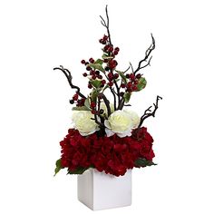 a white vase filled with red and white flowers