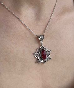 Introducing our stunning handcrafted filigree art blossoming lotus flower figured pendant necklace, featuring a breathtaking ruby corundum gemstone. This elegant necklace is made of high-quality 925 sterling silver and measures 20 inches in length, with a pendant height of 1.70 inches and a width of 1.20 inches. The July birthstone ruby corundum gemstone is a faceted oval cut that measures 7.00x14.00 mm, adding a touch of luxury to this already exquisite piece. Each necklace comes with a silver Luxury Victorian Flower Pendant Necklace, Silver Ruby Necklace, Elegant Flower Pendant Necklaces With Natural Stones, Elegant Flower Pendant Jewelry With Natural Stones, Lotus Jewelry Design, Exquisite Gemstone Flower Pendant Jewelry, Exquisite Teardrop Pendant Necklace As A Gift, Red Flower Shaped Gemstone Jewelry, Red Flower-shaped Gemstone Jewelry