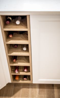 an open cabinet with many bottles in it