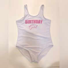 Girls “Birthday Girl” One Piece Swimsuit; Little Girls Size Xs/Size 6. White One Piece With Light Pink Writing. Ordered For My Daughter’s Birthday, She Wore It Once For An Hour Or Two So It’s In Excellent, Gently Worn Condition (Basically Brand New). Ordered From A Boutique Online! #Girlswimwear #Girlsbirthday #Littlegirlsbirthday #Childrensswim #Kidswim #Girlsswim #Girlsbirthday #Birthdayonepiece #Kidsswimwear #Kidsswim #Kidsonepiece #Kidsswimonepiece Cute White Bodysuit For The Beach, Cute White Bodysuit For Beach, Playful Summer Party Bodysuit, Playful Bodysuit For Summer Parties, Fitted Bodysuit For First Birthday In Summer, Birthday Fitted Letter Print Bodysuit, Cute Fitted Bodysuit For Birthday, White Fitted Fun Bodysuit, Fun Fitted White Bodysuit