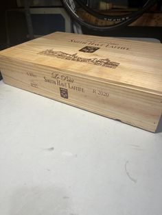 a wooden box sitting on top of a white counter next to a bike tire rack