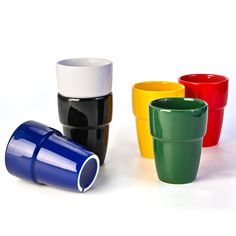 four different colored cups sitting next to each other