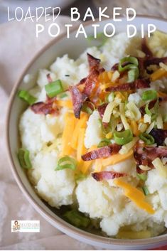 a bowl filled with mashed potatoes topped with bacon and cheese