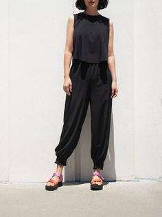 "Beat the heat on sunny days with these light weight parachute pants Inspired by Buddhist monk wear in Korea Constructed relaxed fit with elasticised waist for comfortable wear Ankle cuff detail add a touch of loveliness to this laid-back design -Made of silky polyester fabric -Sits on naval waist -Elastic is inserted in waist area for easy pull up -Relaxed fit -Drops to ankle  -Inseam pockets -Ankle cuff *Model is 26\" waist, 36\" hips and 5'3'' and wearing size Small pants *Material- stretch p Stretch Harem Pants For Summer, Summer Parachute Pants With Elastic Waistband And Tapered Leg, Casual Stretch Harem Pants For Summer, Casual Stretch Summer Harem Pants, Versatile Parachute Pants With Elastic Waistband For Summer, Versatile Summer Parachute Pants With Elastic Waistband, Summer Versatile Cargo Pants With Loosely Fitted Hips, Versatile Summer Cargo Pants With Loosely Fitted Hips, Versatile Wide Leg Parachute Pants For Summer