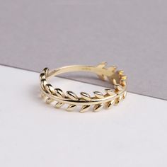 This 14K gold leaf ring is a beautiful and unique piece of nature-inspired jewelry. The ring features a delicate gold leaf branch design that adds a touch of elegance to any outfit. The rose gold color of the leaf adds a romantic touch to the ring. The twig design of the ring makes it perfect for layering with other rings, and the vine-like design gives it a natural and organic feel. This ring would make a great gift for any occasion, such as Mother's Day, Christmas, Father's Day, New Year's Day Nature-inspired Gold Flower Ring For Anniversary, Nature-inspired Yellow Gold Open Ring Jewelry, Nature-inspired Yellow Gold Ring Jewelry, Nature-inspired Yellow Gold Ring, Leaf-shaped Yellow Gold Wedding Jewelry, Leaf-shaped Yellow Gold Jewelry For Weddings, 14k Gold Nature-inspired Ring, Nature-inspired Gold Open Ring Jewelry, Nature-inspired Yellow Gold Promise Ring