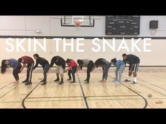 a group of people standing on top of a basketball court with the words skin the snake