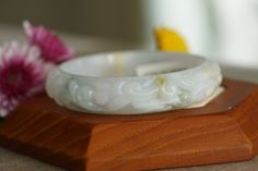 ♡This is a Natural Grade A Burmese (Myanmar) Glutinous ice Hand Carved Jadeite bangle, with a little green and yellow color(has a certification in China). ♡ Carved pattern：花開富貴，flower, leaf（meanings Bloom and prosper） ♡It's a finished product, you can get the style and color from the picture. ♡ The bangle Size: Inner diameter 58mm，Width14.4mm, thickness8.7mm. ♡Please note the original colors may be a little bit different from what you see on your monitor. ♡Postal services to certain destinations White Bangle For Gift, White Carved Bracelets, White Carved Round Bracelet, Carved Jade Bangle As A Gift, Handmade Round Jade Bangle, Handmade Green Jade Bangle, Jade Bracelet Bangles Chinese, Minimalist Bangle, Carved Green Jade Bangle