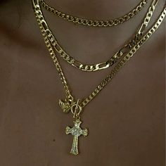 - Cross and cherub / angel necklace - Flat curb chain - Toggle clasp - Hand set clear CZ stones on cross - 14 karat gold or silver plated - Made to last - Length: 18" Gold Cross Necklace Stack, Gold Jewelry Cross, Money Necklace, Xoxo Jewelry, Cross Necklace Gold, Evry Jewels, Dope Jewelry Accessories, Cherub Angel, Angel Necklace