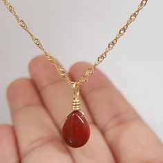 Introducing our stunning, handcrafted Red Jasper necklace with Pyrite accents, set in 18K Gold Filled chain. This exquisite piece of jewelry showcases the natural beauty and vibrant hues of Red Jasper, complemented by the sparkling Pyrite. Its unique and eye-catching design makes it the perfect accessory for any outfit, adding a touch of elegance and sophistication. Red Jasper is known for its grounding and stabilizing properties, while Pyrite is believed to promote prosperity and success. Toget Red Jasper Pendant, Affordable Red Spiritual Necklace, Red Gemstone Drop Necklace For Gift, Gold Teardrop Pendant Necklace With Wire Wrapped, Gold Wire-wrapped Drop Necklace As Gift, Gold Teardrop Wire Wrapped Necklace, Gold Wire Wrapped Drop Necklace As Gift, Gold Wire-wrapped Drop Necklace For Gift, Gold Wire Wrapped Drop Necklace For Gift