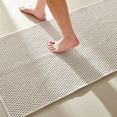 a close up of a person's feet on a mat with no shoes in the room