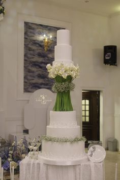 a white wedding cake with flowers on top