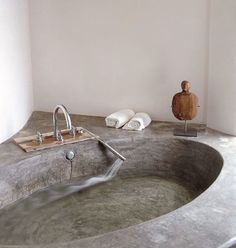 a bathtub with water running from the faucet