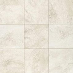 a white tile wall with several squares in it