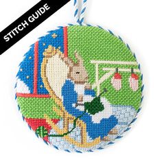 a cross stitch ornament with an image of a cow and basketball hoop on it