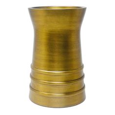 a gold colored vase sitting on top of a white surface