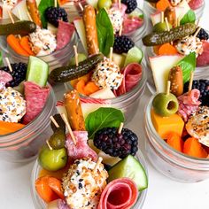 three plastic trays filled with different types of fruit and veggies next to each other