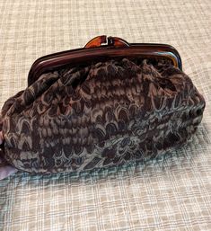 Vintage Carpetbags of America   Closure 9" Bag 10" 2.5" Deep. Peacock pattern in browns. The edges of the handle are broken.   Still usable.  Granna estate find Brown Leather Handle Clutch For Daily Use, Brown Clutch With Leather Handles For Daily Use, Brown Pouch Clutch With Detachable Handle, Brown Handheld Clutch With Removable Pouch, Brown Clutch With Detachable Handle, Brown Leather Satchel Clutch With Handles, Brown Clutch With Top Carry Handle For Everyday Use, Brown Clutch With Handles For Everyday Use, Brown Clutch With Detachable Handle For Daily Use