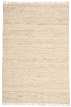 a white rug with fringes on the bottom and one side is shown in light beige