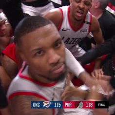 the basketball player is surrounded by his team mates