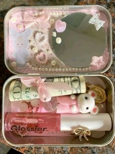 an open tin box filled with baby items