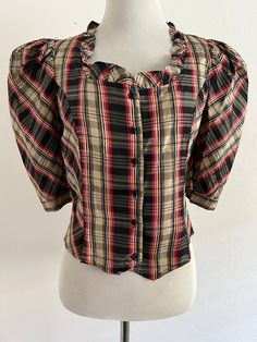 "Really cute 70's fitted ruffled blouse.  \"Judy Knapp\" of California  Acetate Armpit 17\" Shoulder to hem 18\" Very good condition with two tiny white spots that I could not remove that are barely noticeable with the print. (See photo)." Fitted Plaid Puff Sleeve Blouse, Plaid Fitted Blouse With Puff Sleeves, Fitted Plaid Blouse With Puff Sleeves, Vintage Fitted Top With Ruffles, Fitted Vintage Top With Ruffles, Vintage Plaid Top For Spring, Vintage Plaid Spring Tops, Vintage Short-sleeve Blouse With Ruffles, Vintage Tops With Ruffles And Peter Pan Collar