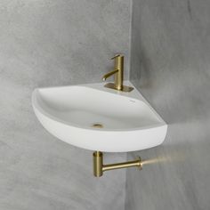 a white sink mounted to the side of a wall